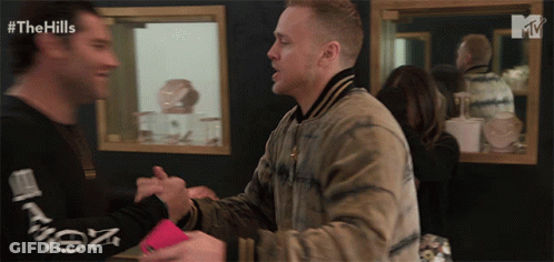 Two Men Shaking Hands In Front Of Mirror GIF