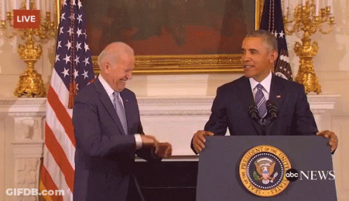 Two Men Shaking Hands In Front Of President Of The United States Podium GIF