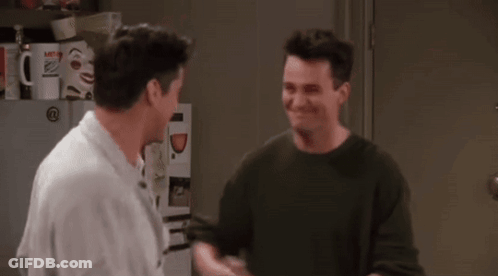 Two Men Shaking Hands In Front Of Refrigerator GIF