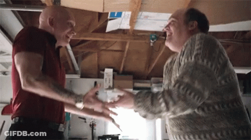 Two Men Shaking Hands In Garage One With Tattoo GIF