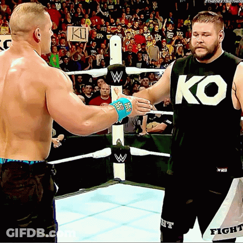 Two Men Shaking Hands In Wrestling Ring One Wearing KO Shirt GIF