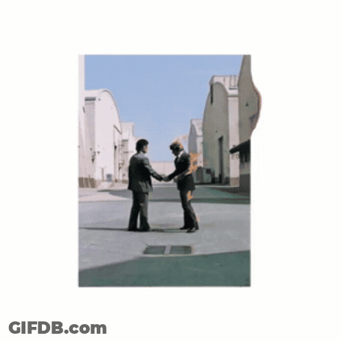 Two Men Shaking Hands Next To Statue GIF