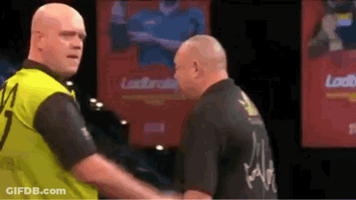 Two Men Shaking Hands On Stage With Loud Sign GIF