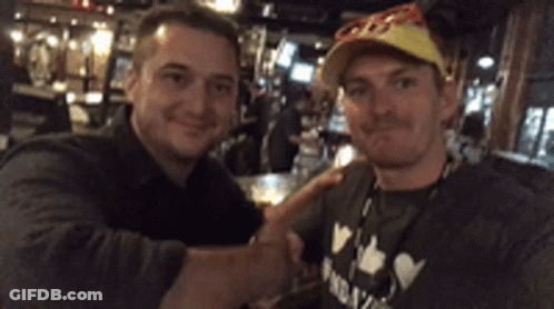 Two Men Shaking Hands With A Shirt GIF