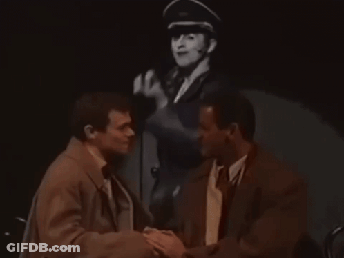 Two Men Shaking Hands With Man In Military Hat GIF