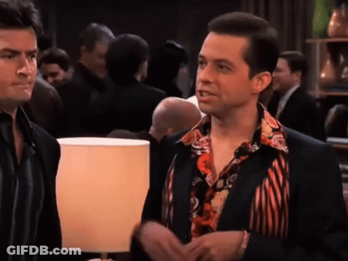 Two Men Side By Side In Crowded Room GIF
