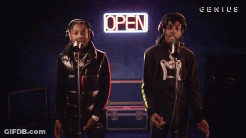 Two Men Sing In Front Of An Open Sign GIF