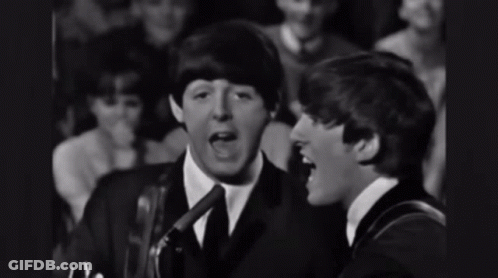 Two Men Singing Into Microphones With Crowd GIF