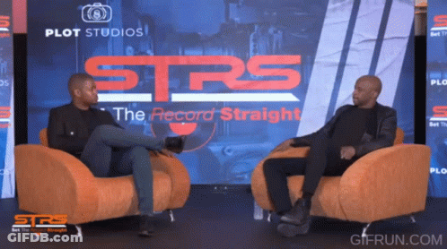 Two Men Sit In Chairs In Front Of A Screen That Says Strs GIF
