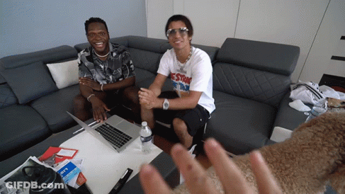 Two Men Sit On A Couch With One Wearing A T-Shirt That Says Estr On It GIF