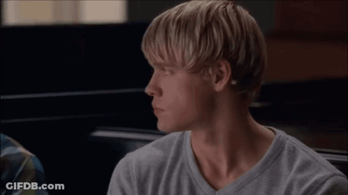 Two Men Sitting And Looking At Each Other GIF