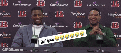 Two Men Sitting At A Table In Front Of A Backdrop That Says Caresource GIF