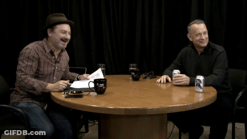 Two Men Sitting At A Table With A Can Of Bud Light GIF