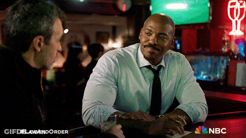 Two Men Sitting At Bar With NBC Logo GIF
