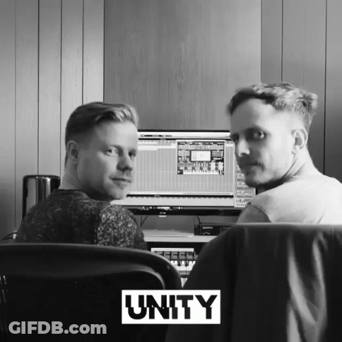 Two Men Sitting At Computer With Unity Above GIF