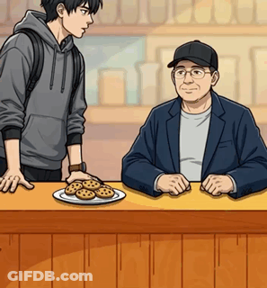 Two Men Sitting At Counter With Cookies GIF