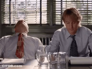 Two Men Sitting At Desk Heads Down GIF