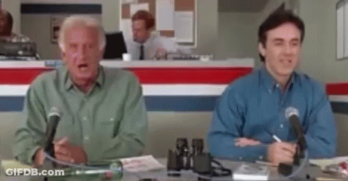 Two Men Sitting At Desk With Microphones GIF