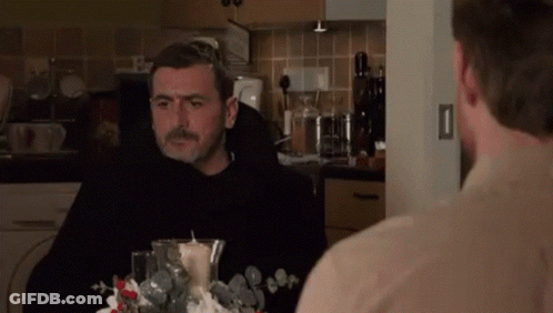 Two Men Sitting At Kitchen Table GIF