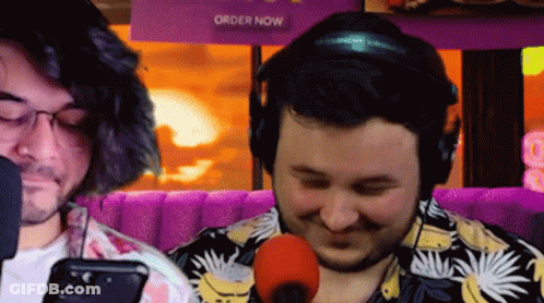Two Men Sitting At Microphone GIF