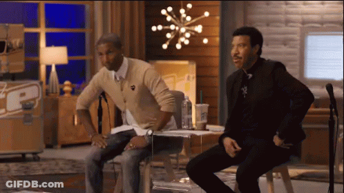 Two Men Sitting At Microphone With TCP Sign GIF
