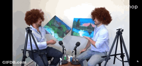 Two Men Sitting At Microphones Holding Paintings Ideashop GIF