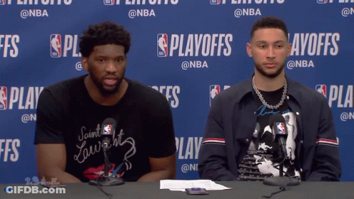 Two Men Sitting At Playoffs Table GIF