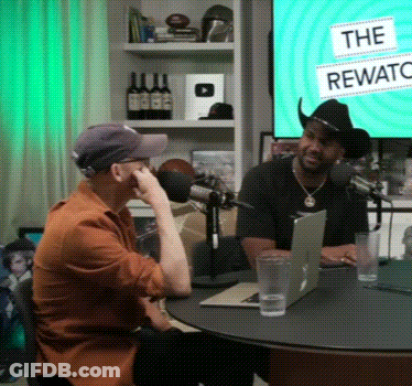 Two Men Sitting At Rewards Sign GIF