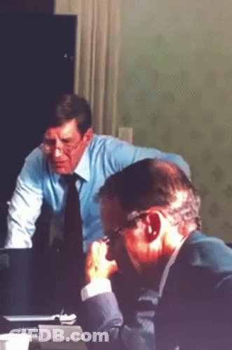 Two Men Sitting At Table Glasses And Blue Shirt Tie GIF