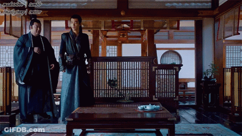 Two Men Sitting At Table GIF