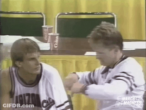 Two Men Sitting At Table One In Arizona Shirt GIF