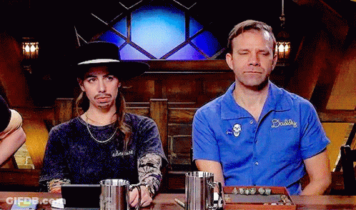 Two Men Sitting At Table One Wearing Daddy Shirt GIF