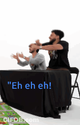 Two Men Sitting At Table Saying Eh Eh Eh GIF