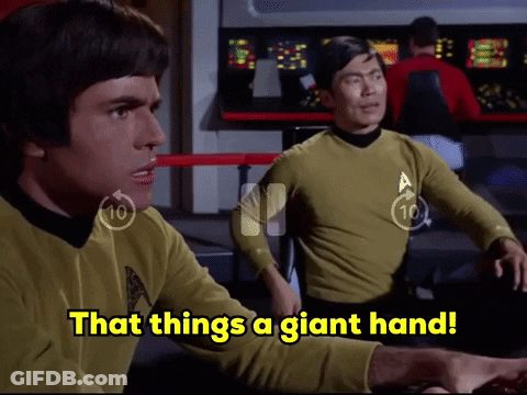 Two Men Sitting At Table Saying That Things A Giant Hand GIF