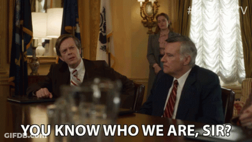 Two Men Sitting At Table Saying You Know Who We Are GIF