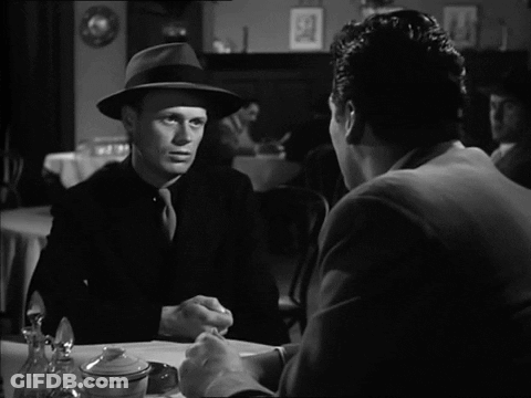 Two Men Sitting At Table Talking GIF
