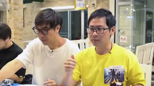 Two Men Sitting At Table With 52 Sign GIF