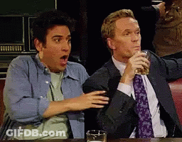 Two Men Sitting At Table With Beer GIF