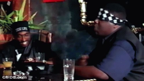 Two Men Sitting At Table With Drinks Snoop Dogg Bandana GIF
