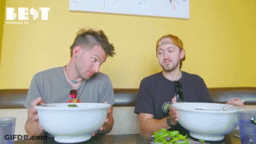 Two Men Sitting At Table With Food GIF