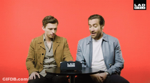 Two Men Sitting At Table With Lad Video Box GIF