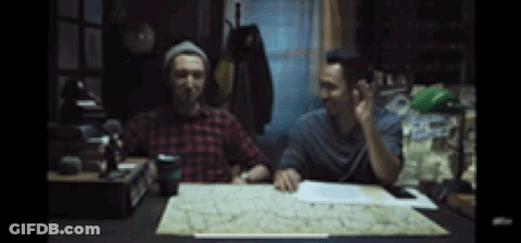 Two Men Sitting At Table With Map Talking GIF