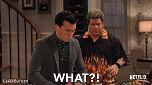 Two Men Sitting At Table With Netflix Logo GIF
