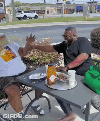 Two Men Sitting At Table With Tabasco Sauce GIF