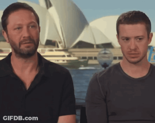Two Men Sitting Beside Boat GIF