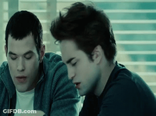 Two Men Sitting By Window Looking At Something GIF