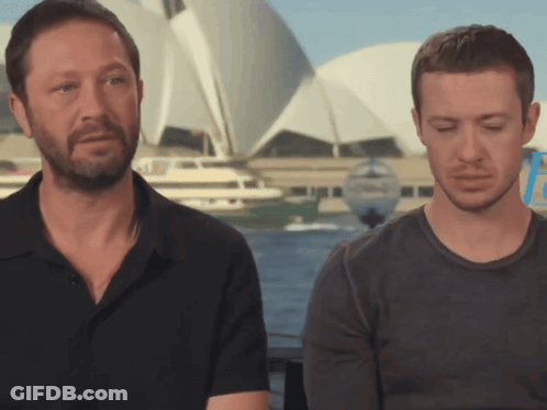Two Men Sitting Eyes Closed GIF