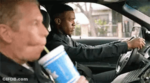 Two Men Sitting In Car Drinking From Cup GIF