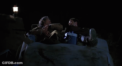 Two Men Sitting In Car With Cooler And No Parking Sign GIF