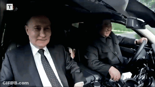 Two Men Sitting In Car With Letter T GIF